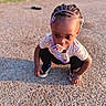 toddler, child, pacifier, braided_hair, beads, outdoor, gravel, sunlight, sneakers, clothing, curious, crouching, person, shadow, playground, daytime, young_child, cute, expression, casual