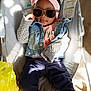 baby, baby_seat, child, clothing, cool_pose, cute, denim_jacket, fashion, headband, indoor, light_and_shadow, monkey_design, pink, portrait, relaxing, sunglasses, sweater, toddler, wooden_floor, yellow_plastic_bag