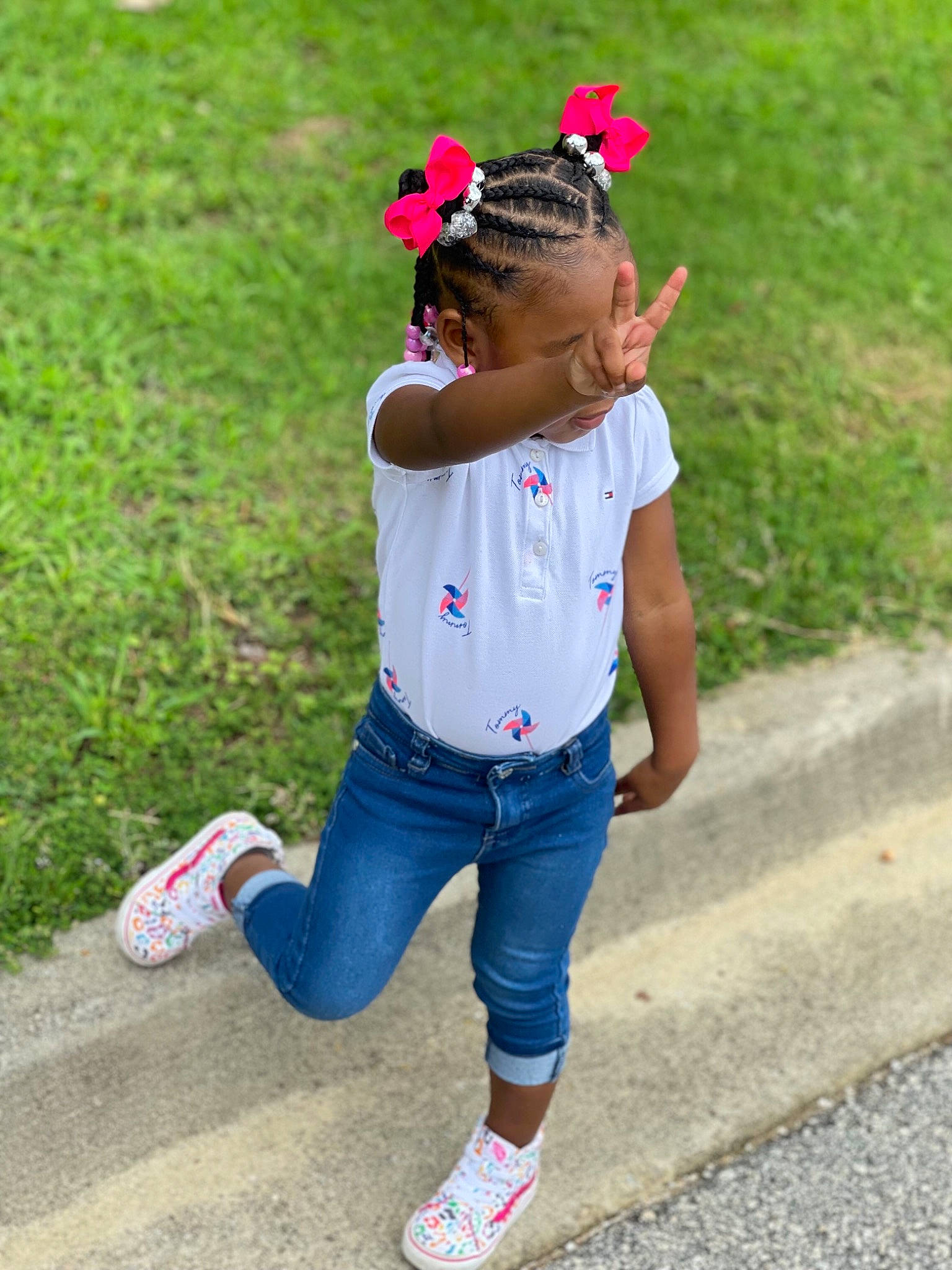 Kaleigh is registered to the contest to win money with this photo: cap, denim, electric_blue, eyewear, flower, grass, happy, jeans, leisure, person, petal, pink, recreation, sneakers, sportswear, street_fashion, summer, t_shirt, thigh, toddler