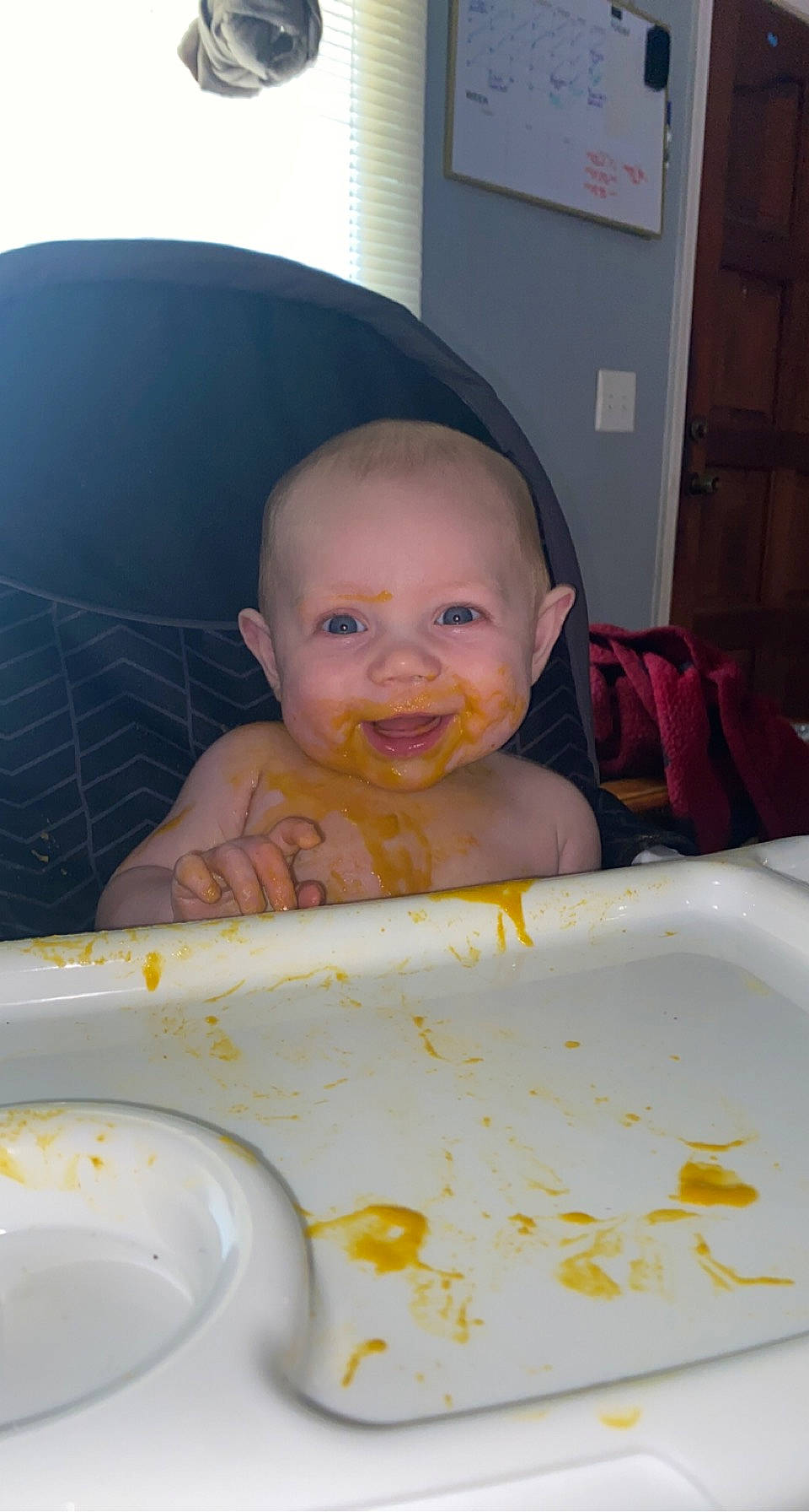 Westyn is registered to the contest to win money with this photo: baby, baby_laughing, baby_toddler_clothing, chair, cheek, child, chin, circle, comfort_food, dishware, facial_expression, flooring, fun, happy, joy, nose, person, room, serveware, smile