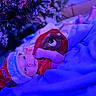 baby, christmas, holiday, festive, hat, blanket, tree, decorations, indoors, infant, cute, portrait, clothing, cozy, toddler, red, blue_light, celebration, lying_down, face