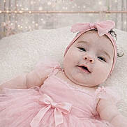 Lindsey is registered to the contest to win money with this photo: baby, baby_girl, infant, portrait, smile, headband, pink_dress, tutu, bow, blanket, soft_texture, studio_background, decorative_bunting, flower_garland, fairy_lights, close_up, cute, newborn, chubby_cheeks, cute_outfit