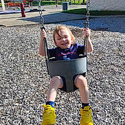 Levi joined the competition — help win amazing prizes! child, toddler, swing, playground, yellow_shoes, smiling, happy, outdoor, sunny, chains, wood_chips, blue_shirt, shorts, park, fun, daylight, feet, grass, trees, recreation