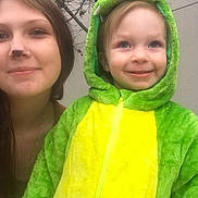 Levi joined the competition — help win amazing prizes! child, woman, costume, dinosaur, green, yellow, smile, face_paint, outdoor, portrait, happy, hood, young, people, casual, fun, nature, tree, closeup, friendship