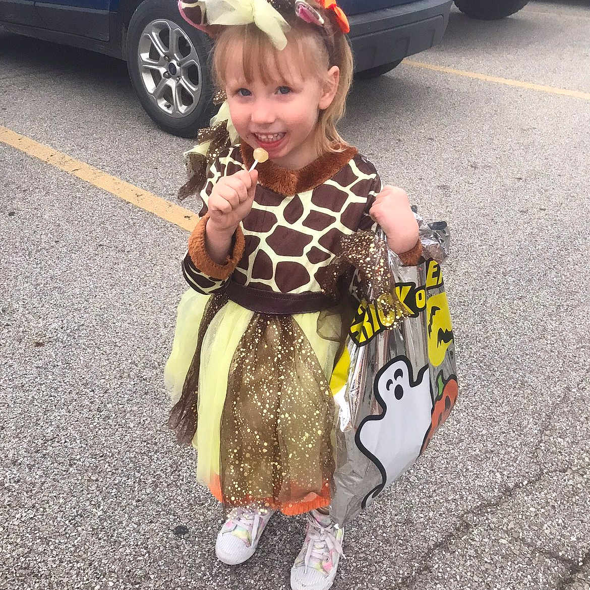 Izabella is registered to the contest to win money with this photo: bag, car, celebration, child, costume, cute, dress, fun, ghost, giraffe, girl, halloween, headband, holiday, lollipop, outdoor, parking_lot, shoes, smile, sparkle