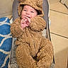 baby, baby_seat, blue_rug, brown, child, cozy, cute, face, fleece, hands, happy, hood, indoor, infant, photography, portrait, sitting, smiling, teddy_bear_costume, tile_floor