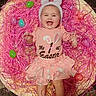 baby, child, easter, bunny_ears, pink, smiling, happy, holiday, celebration, plastic_eggs, grass, festive, cute, infant, apparel, skirt, laying, portrait, fun, indoors