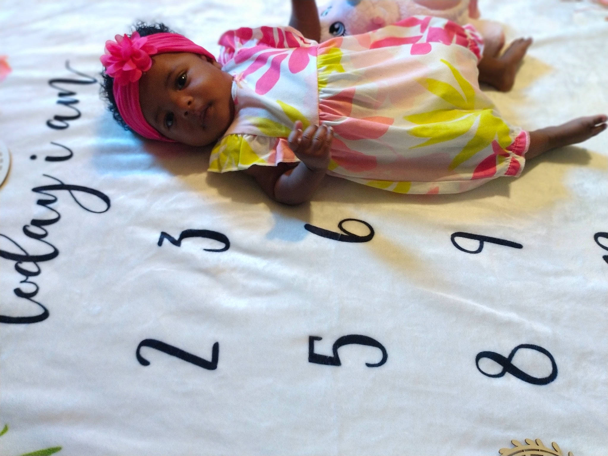 Taraji is registered to the contest to win money with this photo: baby, baby_products, baby_toddler_clothing, bedding, bedtime, cheek, child, comfort, event, font, fun, happy, headwear, leisure, linens, person, pink, play, room, smile