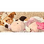 dog, sleeping, plush_toy, pink, flamingo, blanket, cozy, nap, cute, pet, fur, animal, relaxing, indoors, soft, comfort, resting, snuggle, adorable, companion