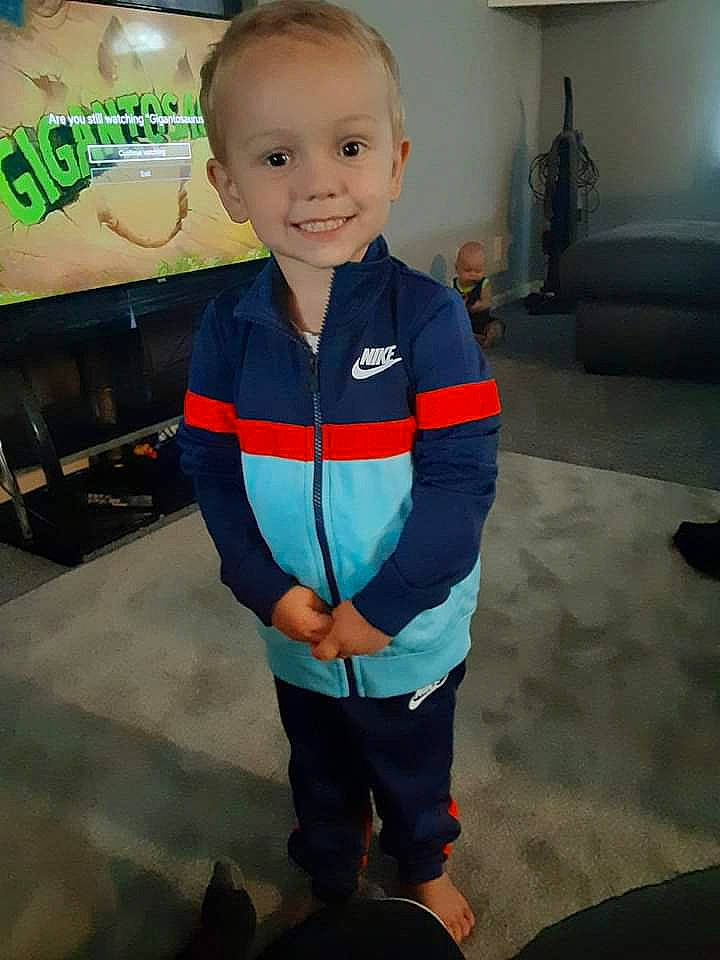 Braeden is registered to the contest to win money with this photo: blurred, child, electric_blue, eye, face, flooring, fun, happy, head, joy, logo, organ, person, picture_frame, room, sleeve, smile, t_shirt, thumb, toddler