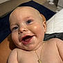 baby, smiling, face, necklace, skin, indoor, person, child, happy, closeup, young, cute, portrait, human, head, expression, bare_shoulders, infant, jewelry, chubby