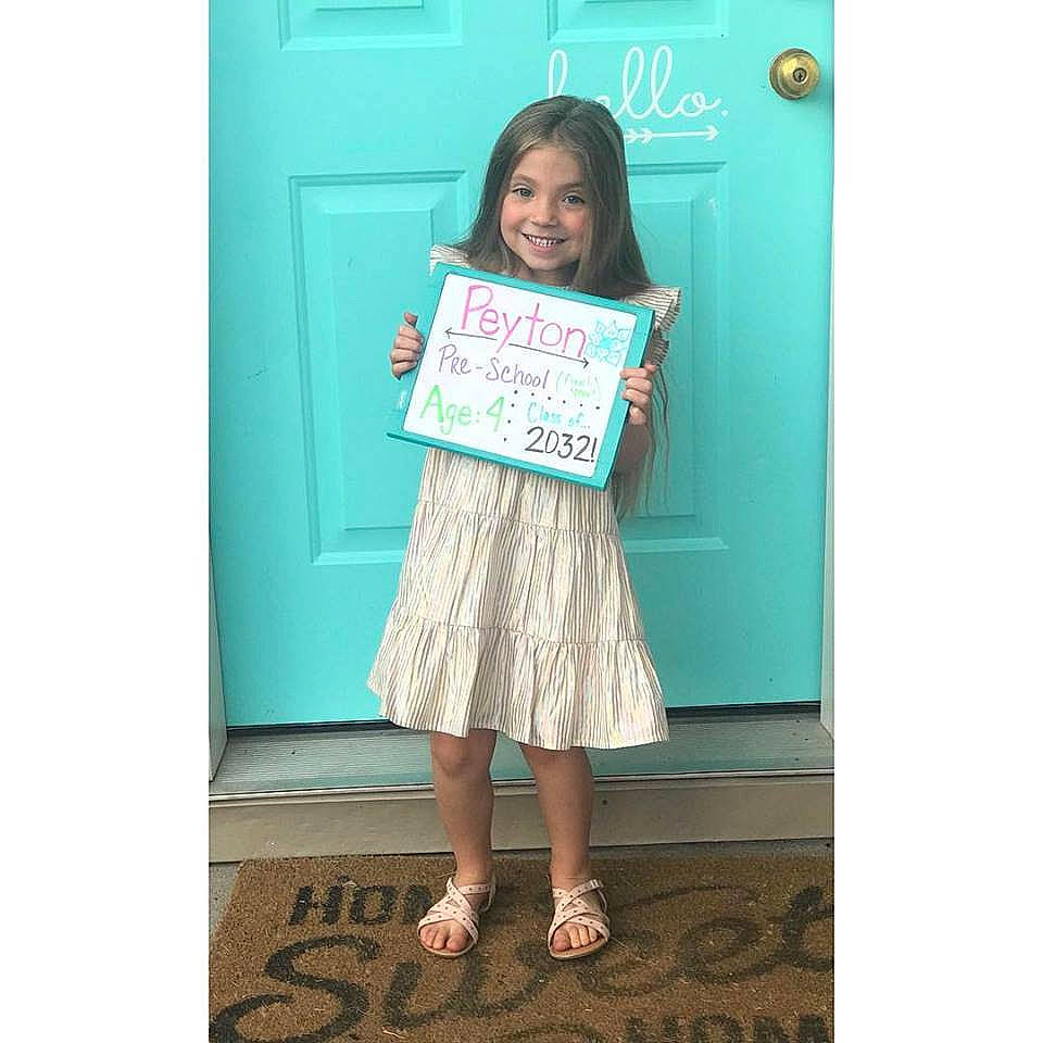 Peyton is registered to the contest to win money with this photo: child, child_model, clothing, dress, joy, pattern, person, sleeve, smile, t_shirt, turquoise