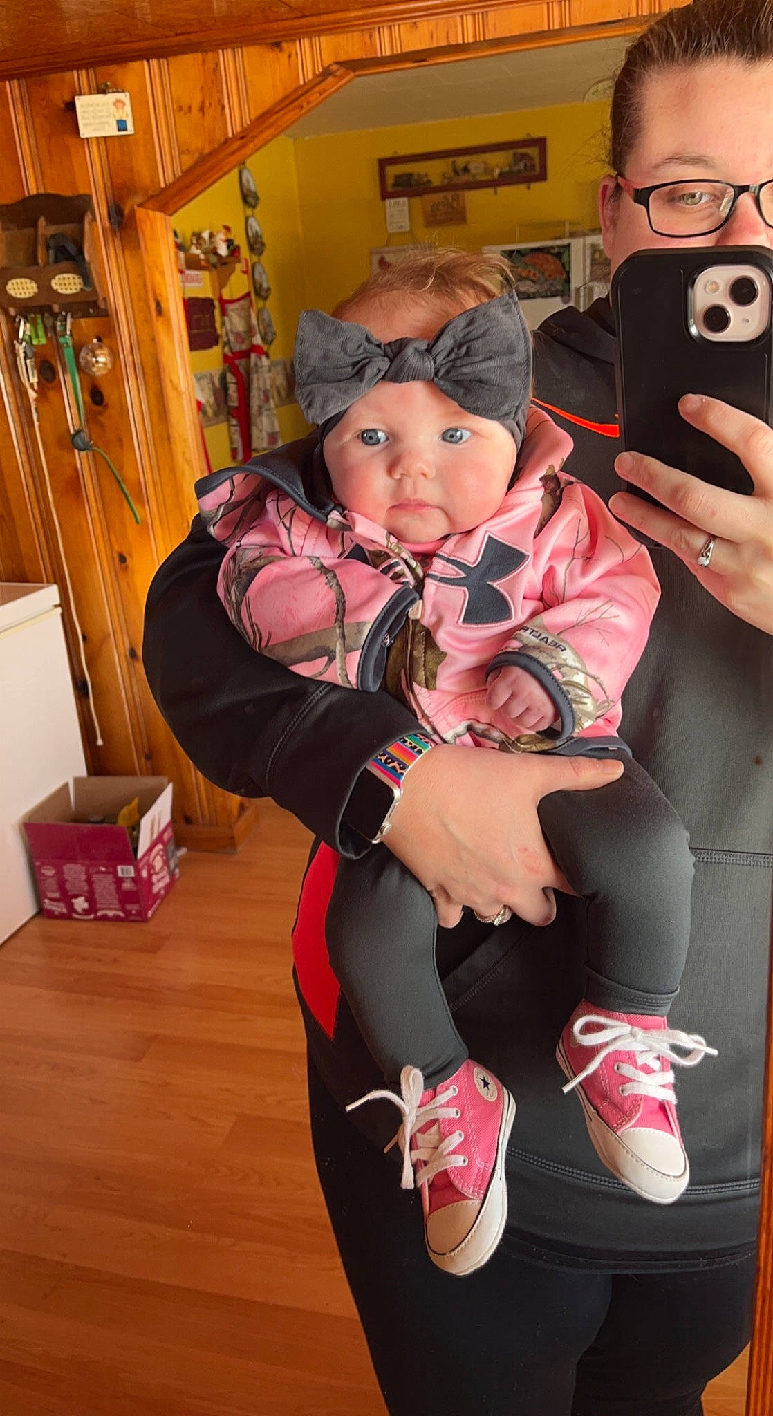 Macey is registered to the contest to win money with this photo: bag, baseball_cap, camera, cameras_optics, event, eye, eyewear, flooring, fun, glasses, hat, human_leg, luggage_and_bags, mobile_phone, person, personal_protective_equipment, sneakers, t_shirt, thigh, toddler