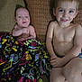 baby, toddler, child, blanket, couch, pillow, smile, shirtless, indoor, patterned, happy, person, sitting, face, head, skin, young, cozy, family, home