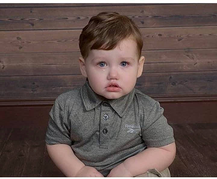 Mason is registered to the contest to win money with this photo: baby_toddler_clothing, blond, brown_hair, cheek, child, chin, ear, eyelash, flash_photography, hairstyle, hardwood, iris, neck, organ, person, shirt, sitting, skin, toddler, wood