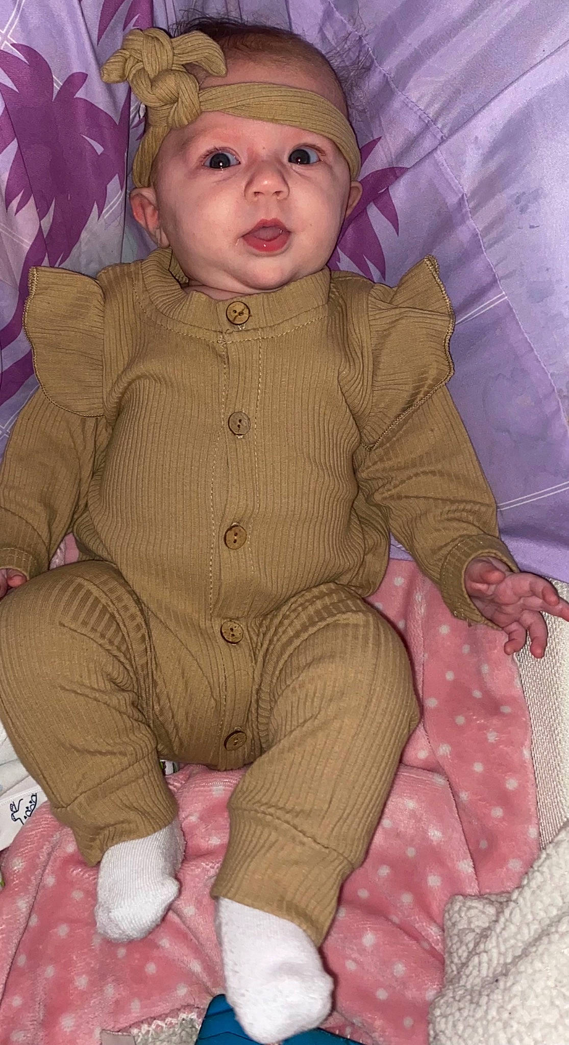 Laila is registered to the contest to win money with this photo: baby, baby_toddler_clothing, cap, cheek, child, face, fashion_accessory, headwear, iris, linens, lip, magenta, pattern, person, pink, sitting, skin, sleeve, textile, toddler