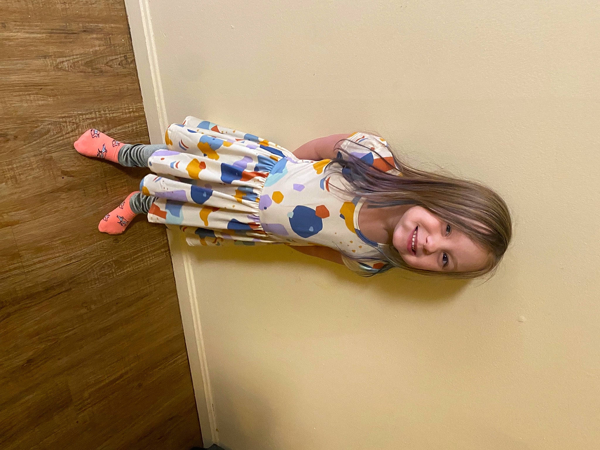 Kaylee is registered to the contest to win money with this photo: comfort, elbow, electric_blue, flooring, fun, happy, hardwood, human_leg, joy, leg, person, room, smile, thigh, varnish, wood, wood_flooring