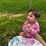 baby, casual, child, cute, daylight, fence, fun, grass, greenery, nature, outdoor, pink_clothing, plastic_bag, playing, sitting, summer, toddler, water_balloon, young_child, youth