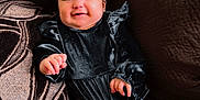 Maeve joined the competition — help win amazing prizes! baby, blanket, bodypart, bonnet, cap, clothing, couch, dress, face, finger, furniture, hand, happy, hat, head, person, photography, portrait, shorts, smile