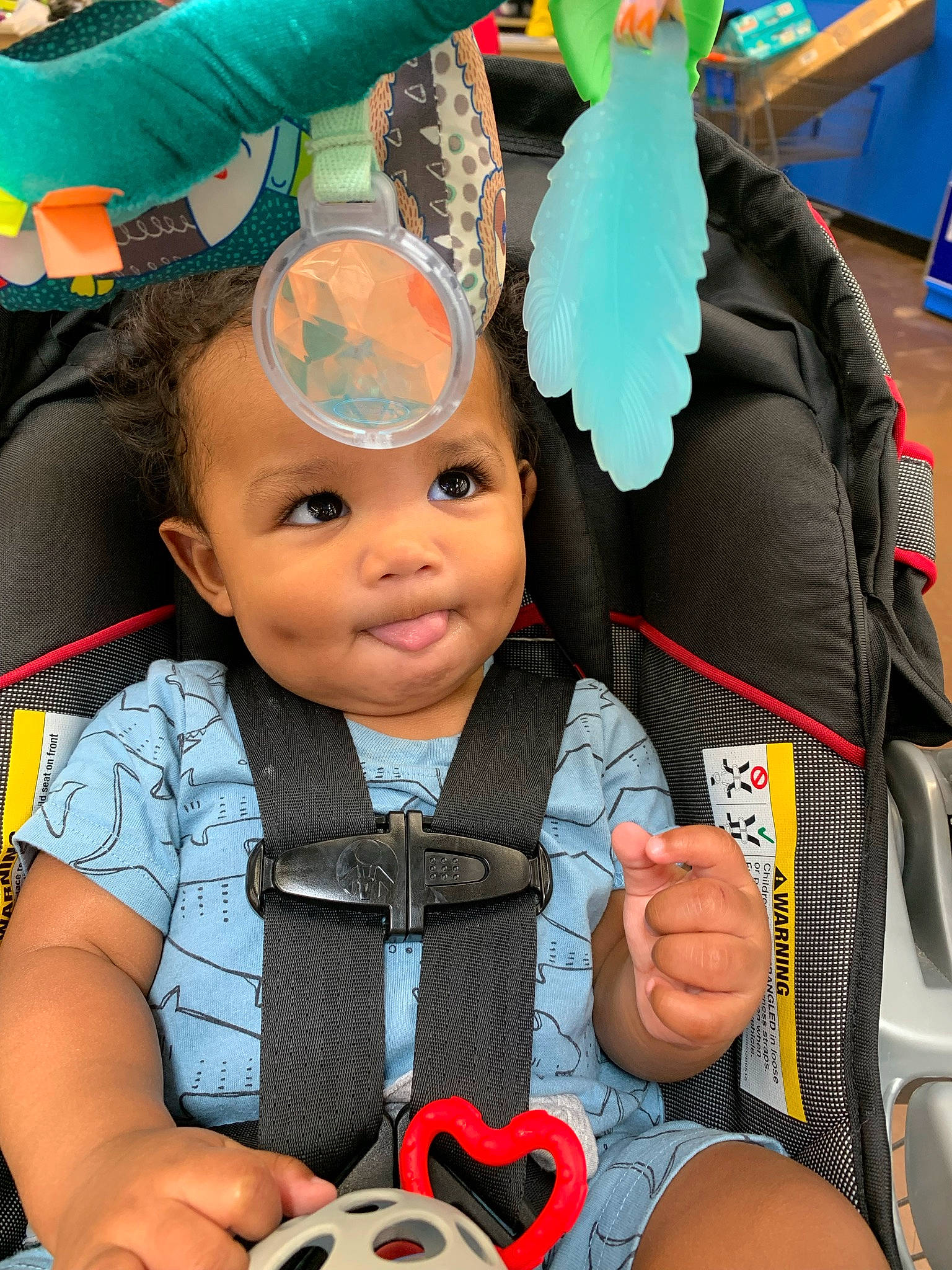 Chandler is registered to the contest to win money with this photo: baby, baby_products, baby_toddler_clothing, blue, car_seat, child, costume, fashion_accessory, fun, green, happy, human, people, person, personal_protective_equipment, product, public_space, sitting, snapshot, toddler