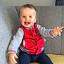 Milann participe au concours pour gagner de l'argent avec cette photo : baby, child, smiling, sitting, red_jacket, gray_couch, indoors, happy, cute, face, person, sock, blue_pants, hands, head, window, wall, furniture, home, portrait
