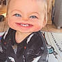 Milann participe au concours pour gagner de l'argent avec cette photo : baby, child, face_filter, distorted_face, smiling, indoors, bat_pattern, clothing, mat, floor, person, cute, young_child, blue_eyes, tooth, sitting, furniture, background, home, soft_lighting