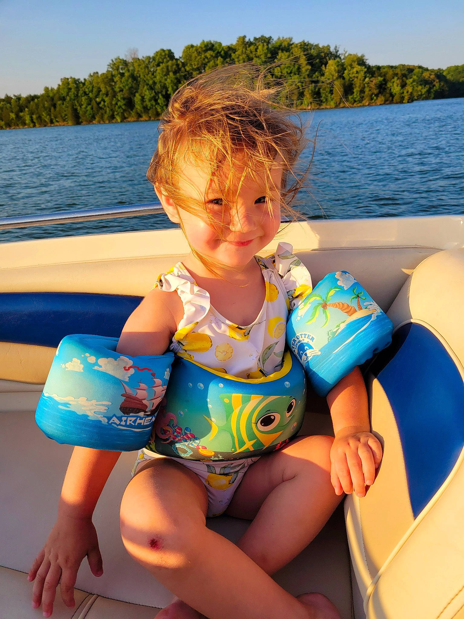 Mackenzie joined the competition — help win amazing prizes! azure, blue, boat, boats_and_boating_equipment_and_supplies, finger, fun, knee, lake, lap, leg, leisure, personal_protective_equipment, recreation, shorts, sky, summer, thigh, toddler, tree, water