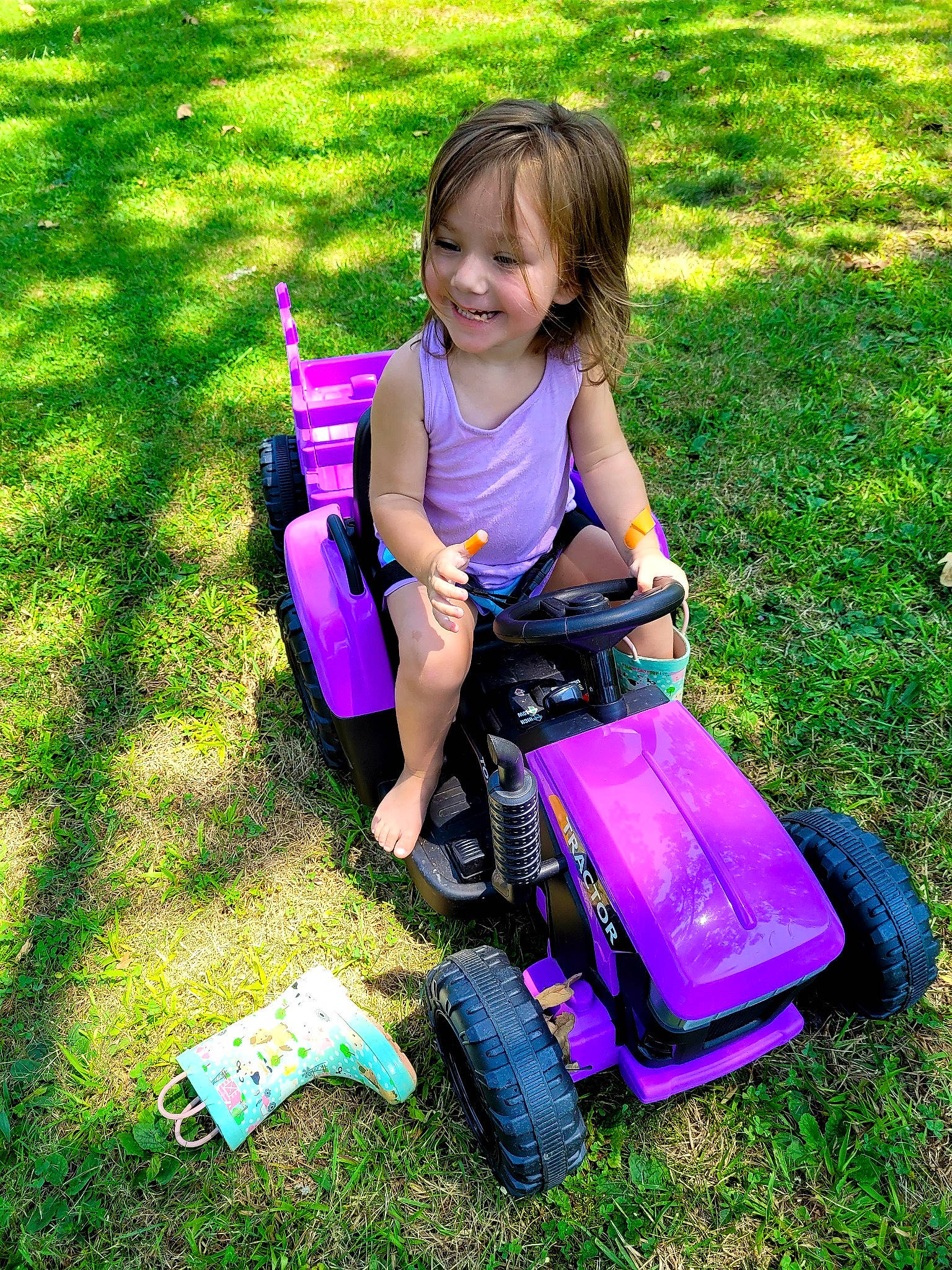 Mackenzie joined the competition — help win amazing prizes! automotive_tire, baby_toddler_clothing, child, fun, grass, happy, joy, leisure, magenta, nature, people_in_nature, person, pink, purple, recreation, riding_toy, smile, summer, tire, toddler