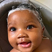 Kariyah is registered to the contest to win money with this photo: baby, child, bath, water, foam, shampoo, smile, face, skin, droplets, head, eyes, ears, shoulders, seat, bathtub, cute, happy, indoors, portrait