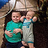 child, baby, smiling, happy, indoor, rug, floor, clothing, onesie, toddler, sibling, portrait, cute, candid, person, feet, tile, blanket, green_shirt, blue_shorts