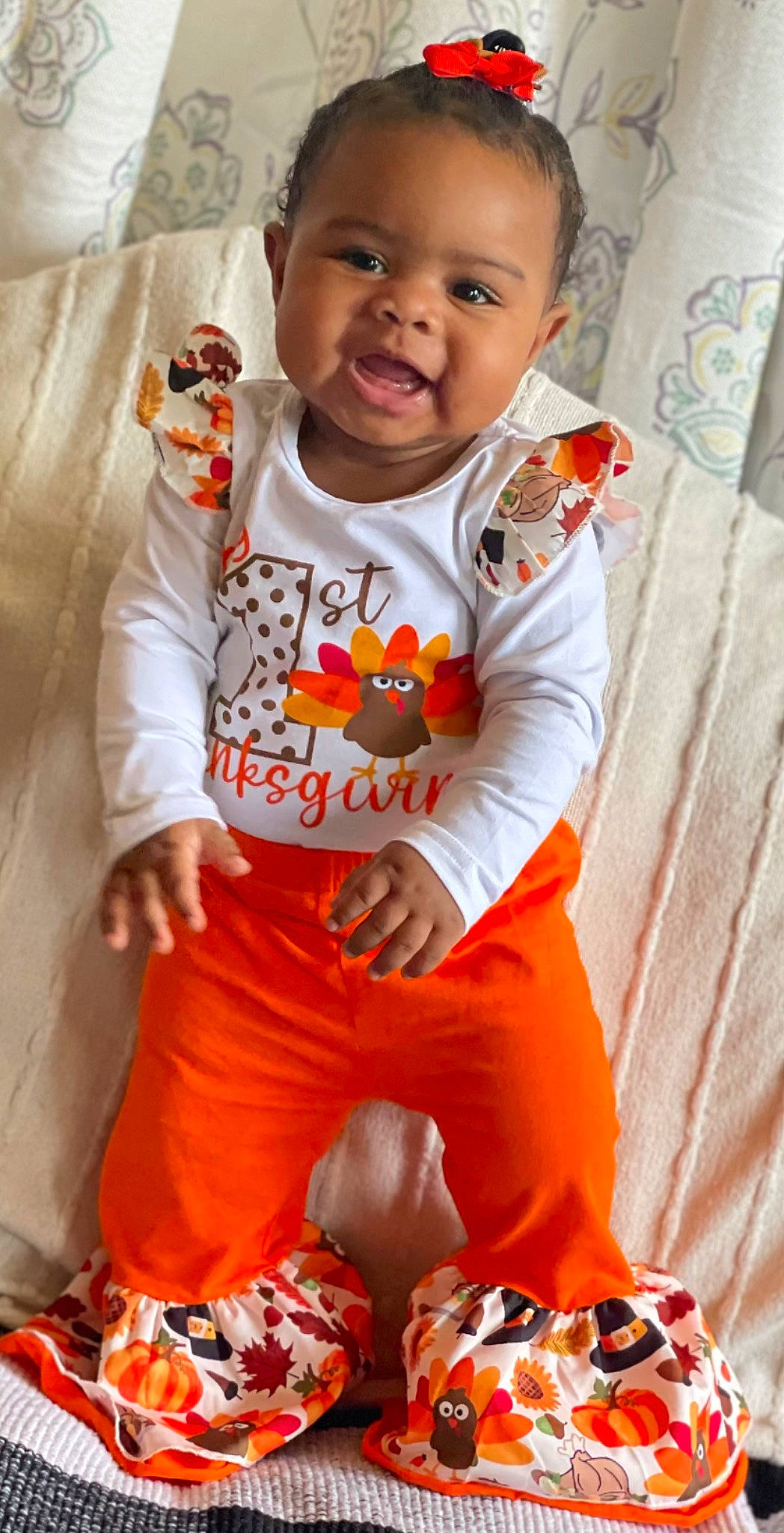 Everleigh is registered to the contest to win money with this photo: active_pants, baby, baby_toddler_clothing, child, flooring, fun, happy, head, long_sleeved_t_shirt, orange, outerwear, pajamas, pattern, person, sleeve, smile, sportswear, t_shirt, thigh, toddler
