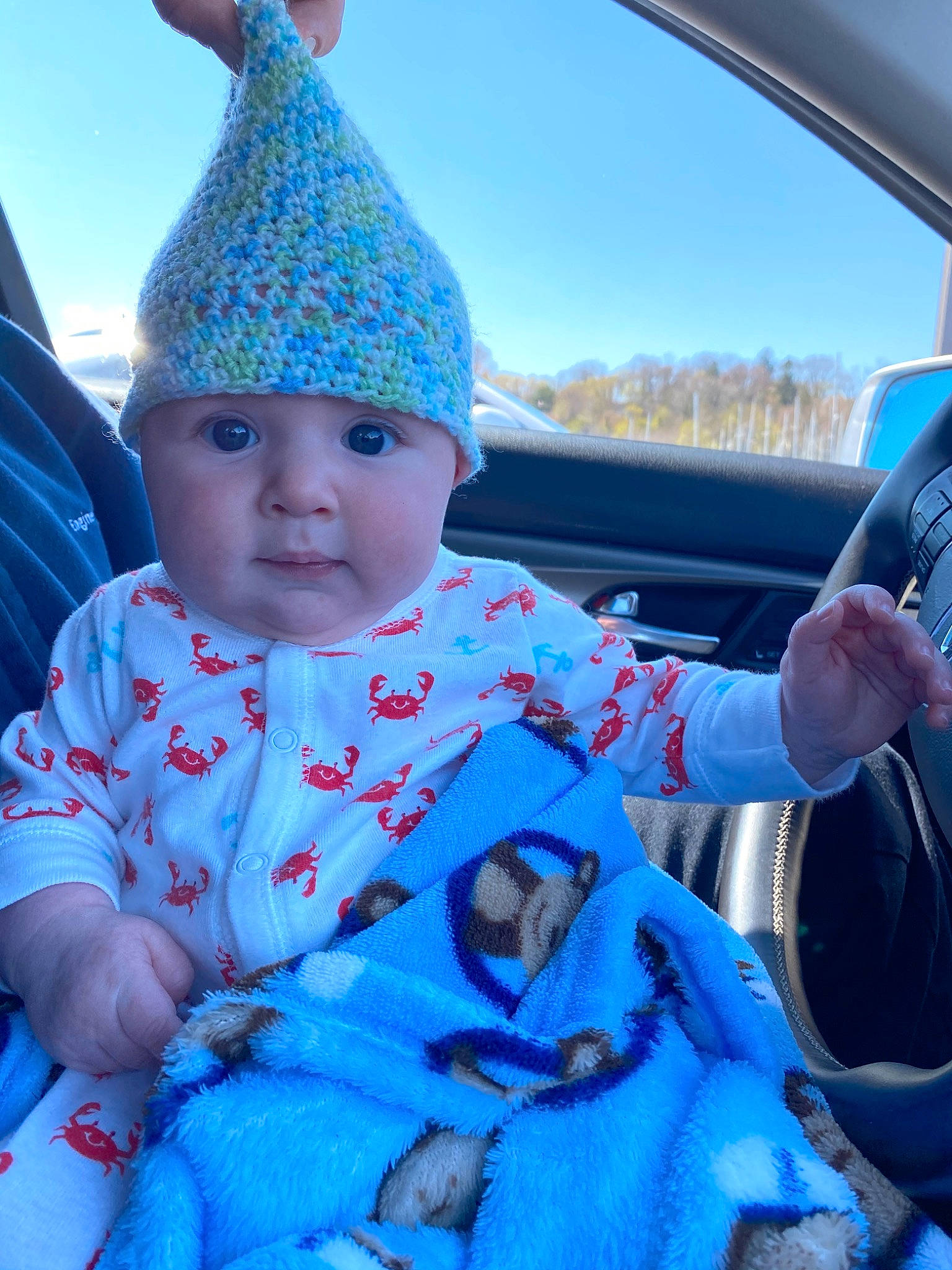 Emerson joined the competition — help win amazing prizes! baby, blue, bonnet, car, car_seat, child, headgear, headwear, outerwear, party_supply, person, sky, toddler