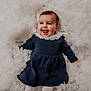 Emy participe au concours pour gagner de l'argent avec cette photo : baby, child, smiling, lying_down, blue_dress, white_collar, fluffy_background, soft_texture, happy, innocence, portrait, cute, infant, one_person, indoor, clothing, face, head, toddler, baby_girl