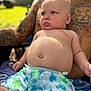 baby, child, tattoo, adult, outdoor, sunlight, shorts, drool, skin, lap, person, portrait, summer, relaxing, bare_chest, blue, green, pattern, casual, expression