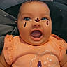 Amiyah Renee joined the competition — help win amazing prizes! baby, child, infant, smiling, laughing, portrait, face, eyes, open_mouth, orange_clothing, onesie, butterfly_stickers, face_filter, sparkles, finger, hand, bedding, indoor, closeup, happy