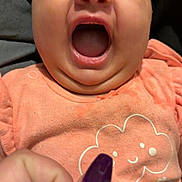 Amiyah Renee is registered to the contest to win money with this photo: baby, infant, child, portrait, close_up, face, smiling, laughing, open_mouth, happy, eyes, peach_clothing, onesie, gingerbread, hearts, hand, fingernail, purple_nail_polish, indoor, couch