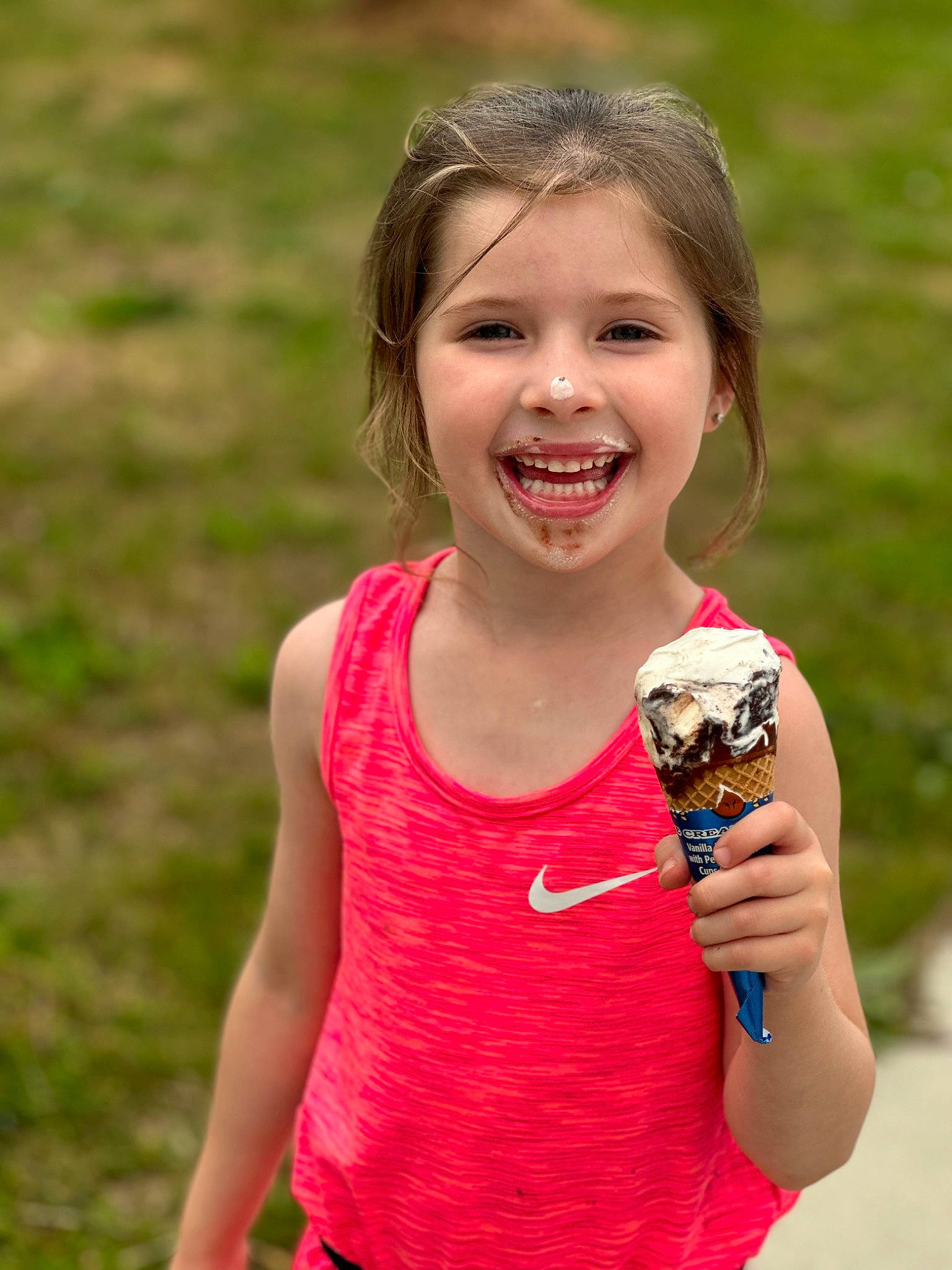 Maleigha is registered to the contest to win money with this photo: child, dessert, food, frozen_dessert, fruit, fun, gesture, grass, grassland, happy, ice_cream, joy, people_in_nature, person, plant, play, portrait_photography, recreation, smile, sweetness
