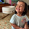 Maricela joined the competition — help win amazing prizes! child, toddler, smiling, happy, indoor, person, short_hair, clothing, pen, furniture, carpet, colorful, toy, cute, portrait, young_child, expression, sitting, home, playful