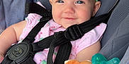 Ailynn is registered to the contest to win money with this photo: baby, smiling, headband, green_bow, stroller, nuna, harness, plush_toy, deer_toy, pacifier, pink_clothing, child, infant, seat, fabric, cute, happy, closeup, person, baby_accessory
