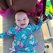 Ailynn is registered to the contest to win money with this photo: baby, smile, blue_eyes, floral_clothing, cushion, bag, pink, green, happy, infant, child, diaper, lying_down, cute, outdoor, bright, colorful, portrait, baby_girl, playful