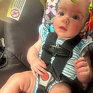 Harper joined the competition — help win amazing prizes! baby, child, car_seat, safety_harness, infant, colorful, pattern, butterfly, clothing, cute, hand, face, seat, straps, expression, indoor, person, skin, young, closeup