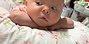 Annabelle joined the competition — help win amazing prizes! baby, bedroom, blanket, child, clothing, cozy, curious, cute, expression, face, floral, head, indoors, infant, person, pillow, resting, skin, soft, young
