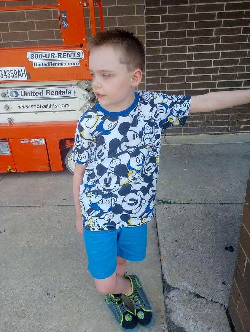 Grayson is registered to the contest to win money with this photo: child, electric_blue, fun, happy, joint, leisure, logo, orange, pattern, person, play, recreation, sleeve, slipper, sportswear, t_shirt, toddler, top, vacation