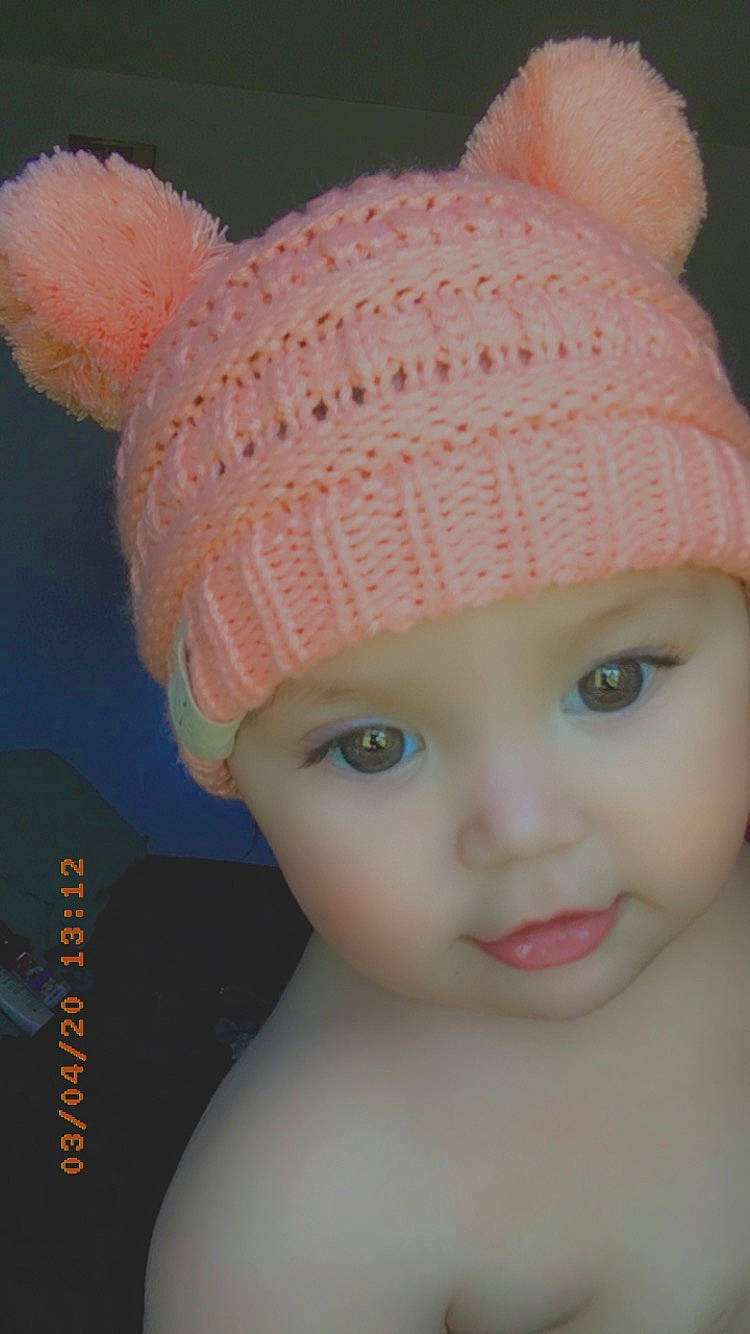 Evyana is registered to the contest to win money with this photo: baby, beanie, bonnet, cap, child, clothing, crochet, ear, fashion_accessory, forehead, hat, head, headgear, headwear, knit_cap, knitting, person, pink, toddler, toy
