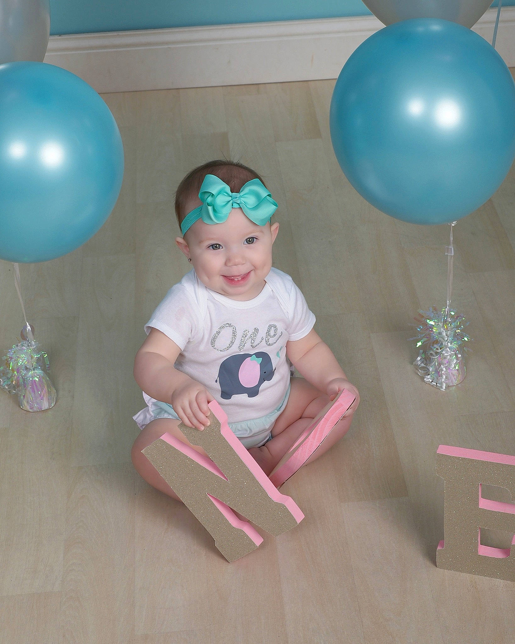 Gracie is registered to the contest to win money with this photo: baby_shower, balloon, birthday, child, joy, party, party_supply, person, pink, toddler, turquoise
