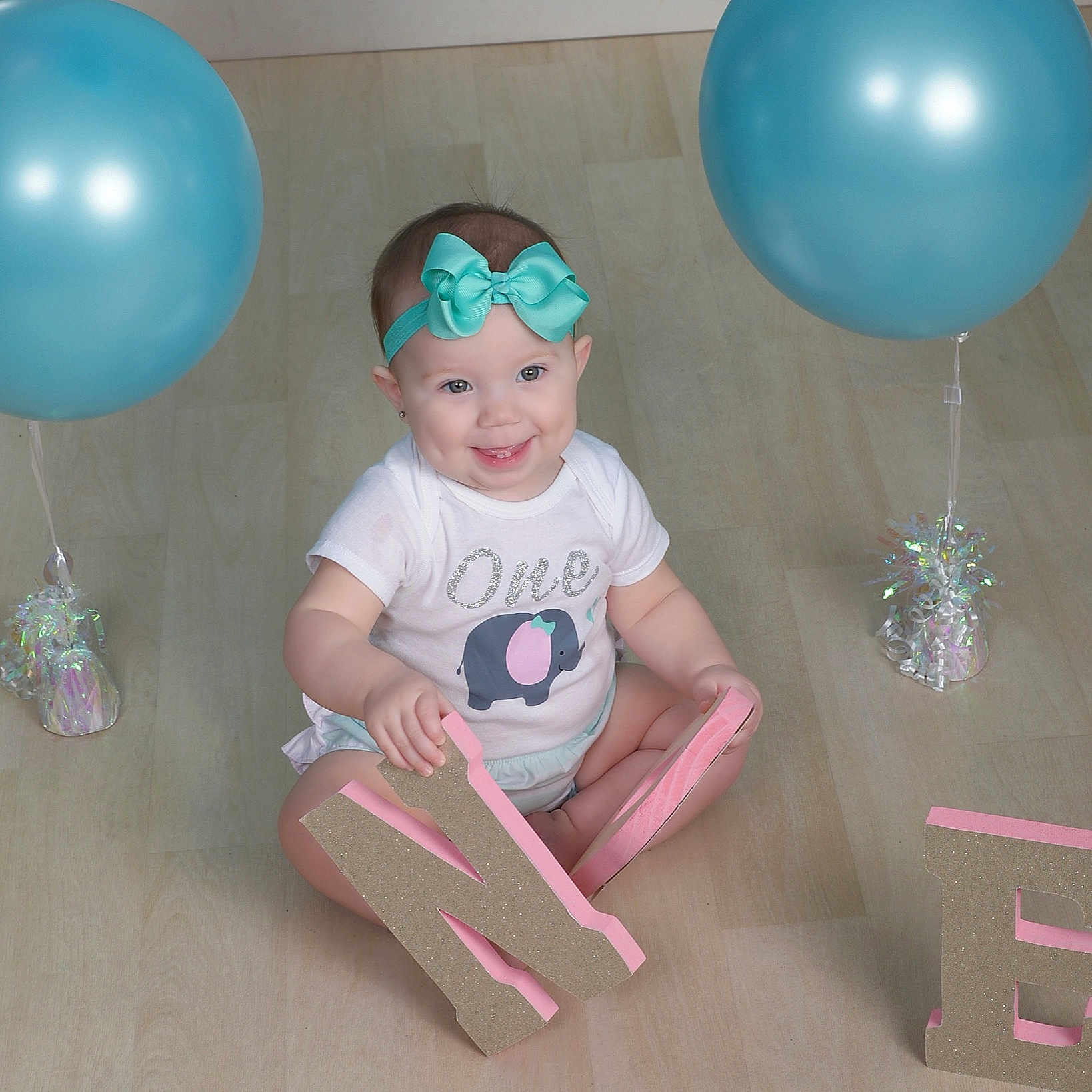 Gracie is registered to the contest to win money with this photo: baby_shower, balloon, birthday, child, joy, party, party_supply, person, pink, toddler, turquoise