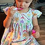 Mylah joined the competition — help win amazing prizes! child, girl, lip_gloss, pigtails, dress, sitting, indoor, concentration, colorful, pattern, bracelet, living_room, couch, furniture, floor, hair, cute, person, skin, beauty