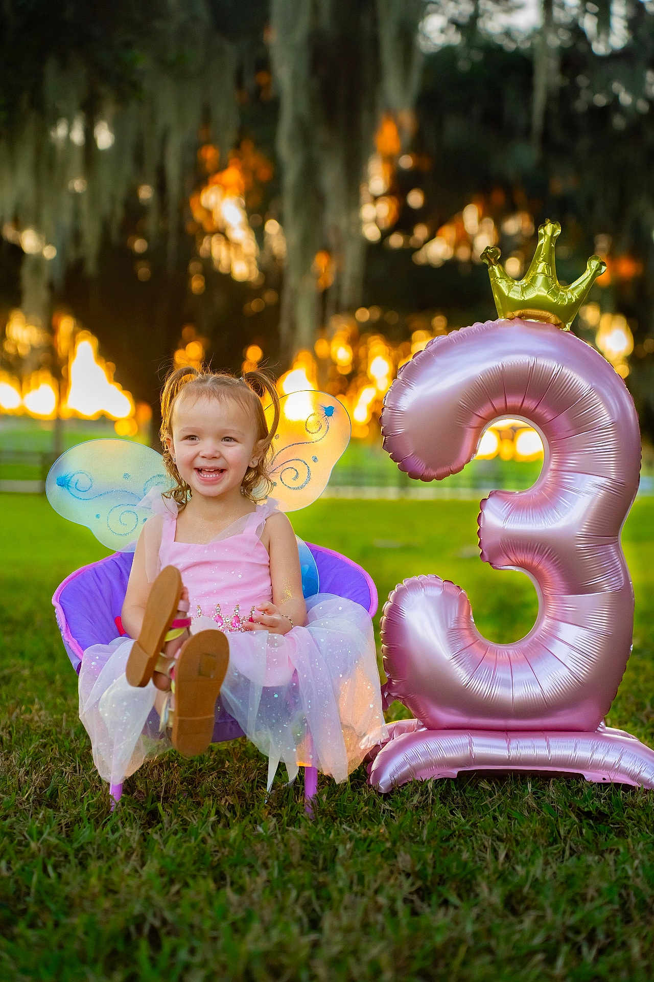 Mylah joined the competition — help win amazing prizes! child, girl, fairy_wings, pink_dress, purple_chair, balloon, number_3, crown, grass, outdoor, sunset, smiling, happy, birthday, party, celebration, young_child, pigtails, sparkle, nature