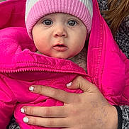 Rori is registered to the contest to win money with this photo: baby, child, hat, pink_jacket, pom_pom, hand, nail_polish, pen_marks, forest, car_interior, winter_clothing, cozy, cute, portrait, outdoor_background, warm_clothes, infant, person, face, expression