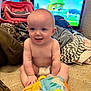 baby, diaper, toy, blanket, couch, television, cartoon, indoor, child, smiling, playful, happy, home, cozy, furniture, soft_toy, colorful, infant, sitting, person